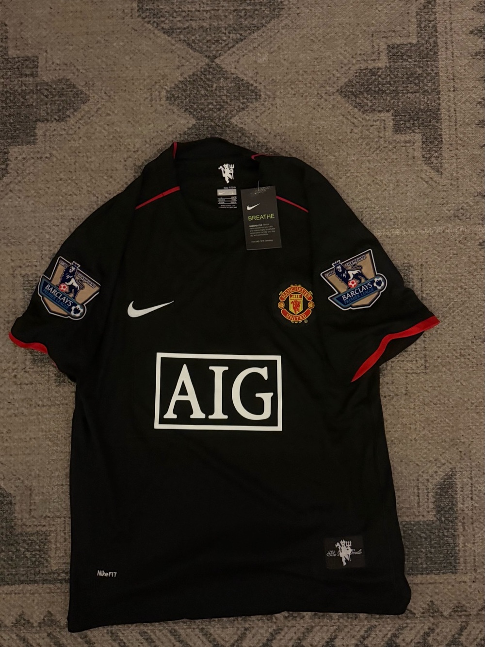 Nike Black Manchester United AIG Football Jersey with Red Trim